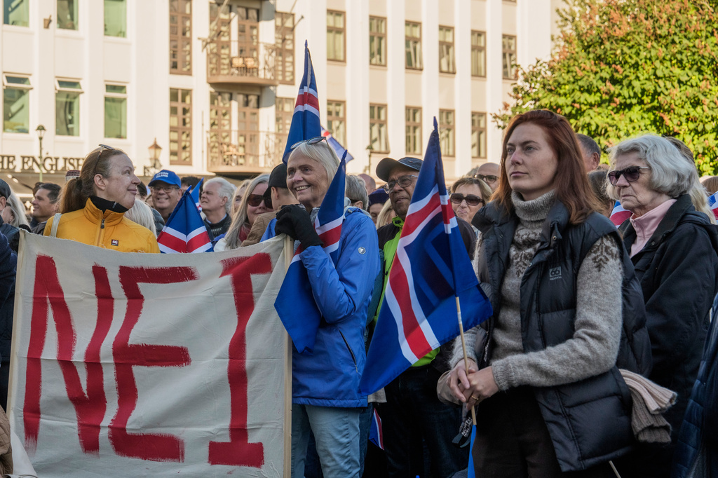 People hold a banner reading "No" as they listen to speakers at an "Afram Island," "Forward, Iceland," rally opposing the resumption of European Union accession talks at Austurvollur in Reykjavik, Iceland, Thursday, Aug. 27, 2026. (AP Photo/Marco Di Marco)