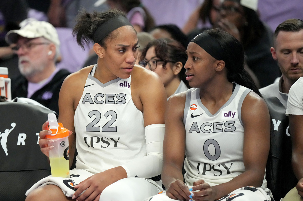Las Vegas Aces center A'ja Wilson (22) talks with guard Jackie Young (0) on the bench in the final seconds of Game 1 of the WNBA basketball semifinals against the Golden State Valkyries in San Francisco, Sunday, Oct. 4, 2026. (AP Photo/Tony Avelar)
