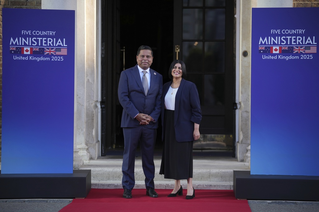 Britain's Home Secretary Shabana Mahmood, right, greets Canada Minister of Public Safety Gary Anandasangaree prior to the Five Country Ministerial meeting at the Honourable Artillery Company in London, Monday, Sept. 8, 2025 as interior ministers of the UK, US, Canada, Australia and New Zealand will discuss some of the major security threats facing our nations. (AP Photo/Kin Cheung)