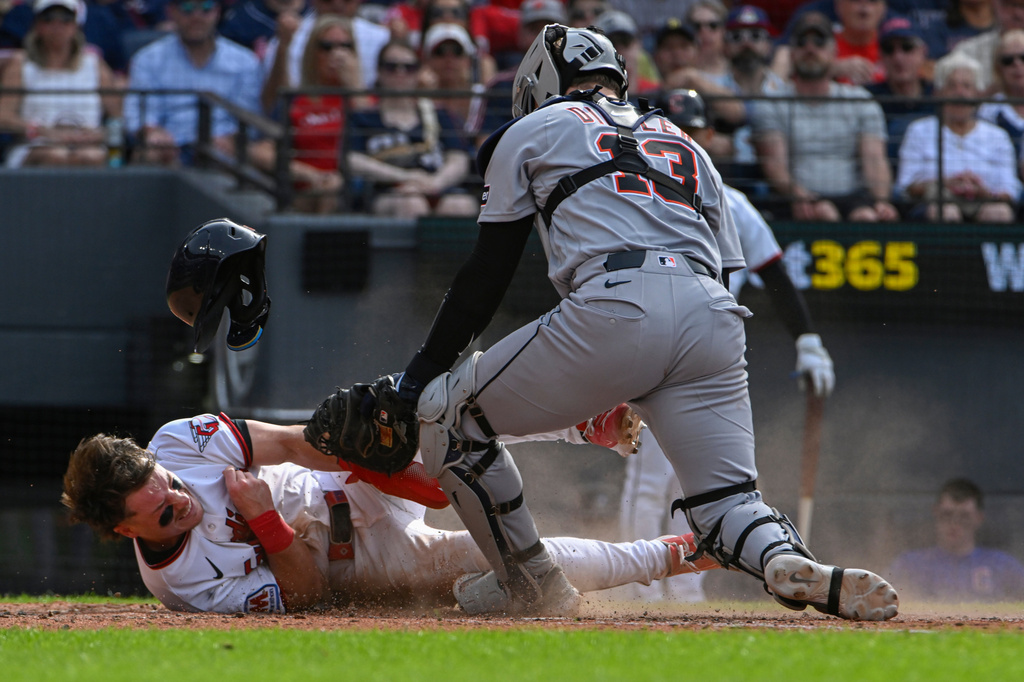 Detroit Tigers' Dillon Dingler (13) tags Cleveland Guardians' Travis Bazzana out at home plate during the fourth inning of a baseball game, Saturday, June 13, 2026, in Cleveland. (AP Photo/Phil Long)
