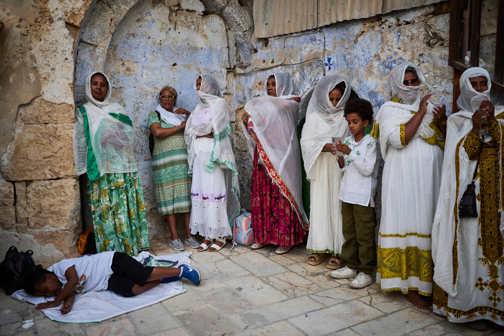 Ethiopian Orthodox Christian worshippers gather for celebrations on the eve of the Meskel holiday at the Ethiopian monks' village, Deir Al‑Sultan, located on the rooftop of the Church of the Holy Sepulcher in Jerusalem's Old City, Saturday, Sept. 26, 2026. (AP Photo/Ohad Zwigenberg)