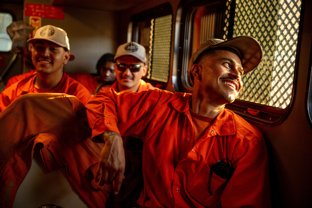 Inmates ride in a vehicle at the Pine Grove Youth Conservation Camp, July 14, 2025, in Red Corral, Calif. (AP Photo/Ethan Swope)
