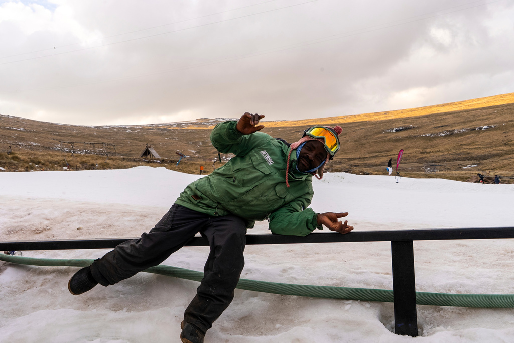 A worker poses near the slopes at Afriski Mountain Resort in Maluti, Lesotho, Saturday, July 11, 2026. (AP Photo/Kayleen Morgan)