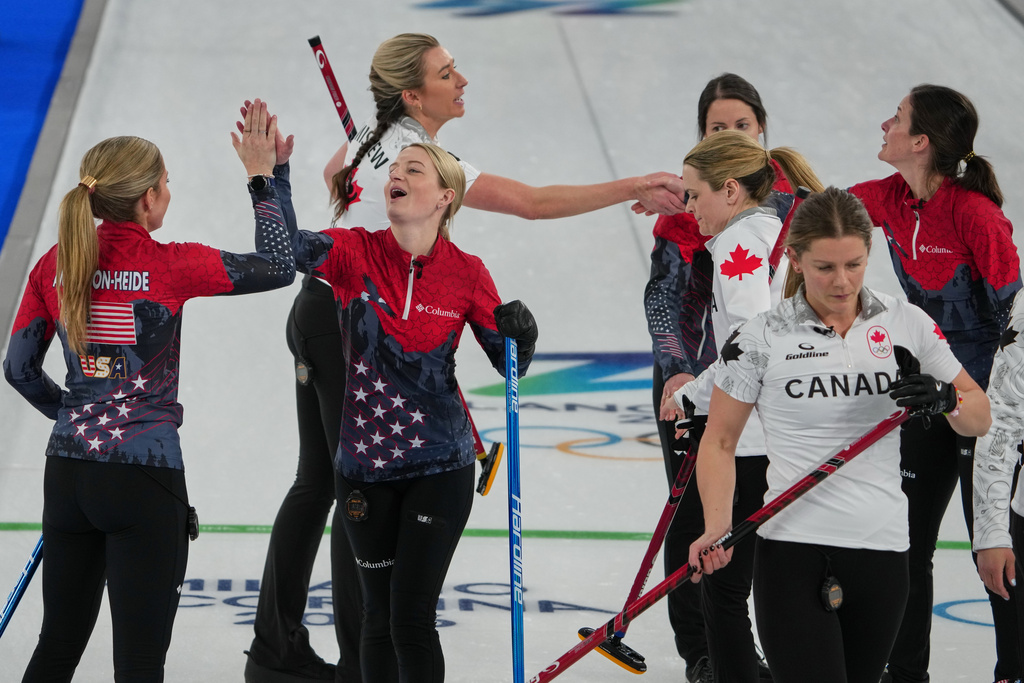 United States' Cory Thiesse, Taylor Anderson-Heide, Tabitha Peterson, and Tara Peterson react after the women's curling round robin session against Canada, at the 2026 Winter Olympics, in Cortina d'Ampezzo, Italy, Friday, Feb. 13, 2026. (AP Photo/Misper Apawu)