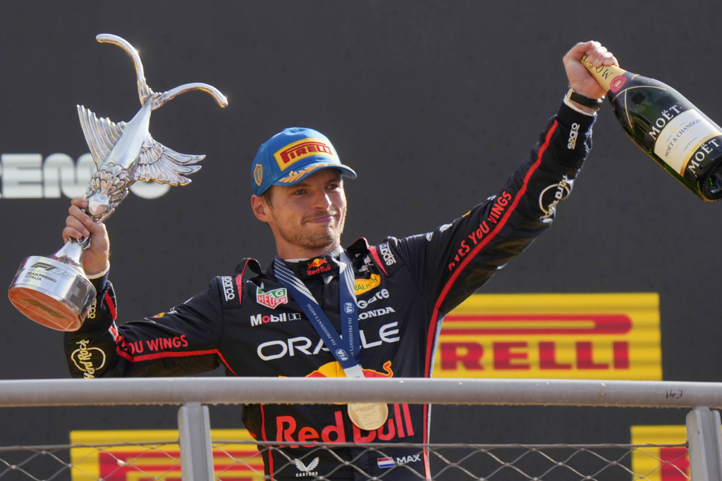 Red Bull driver Max Verstappen of the Netherlands celebrates on the podium after winning the Italian Grand Prix race at the Monza racetrack in Monza, Italy, Sunday, Sept. 7, 2025. (AP Photo/Luca Bruno)