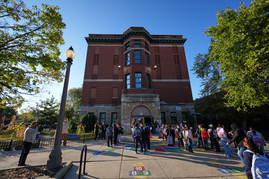 Children line up to enter Funston Elementary School in Chicago's Logan Square neighborhood, at the start of the school day, Thursday, Oct. 16, 2025. (AP Photo/Rebecca Blackwell)
