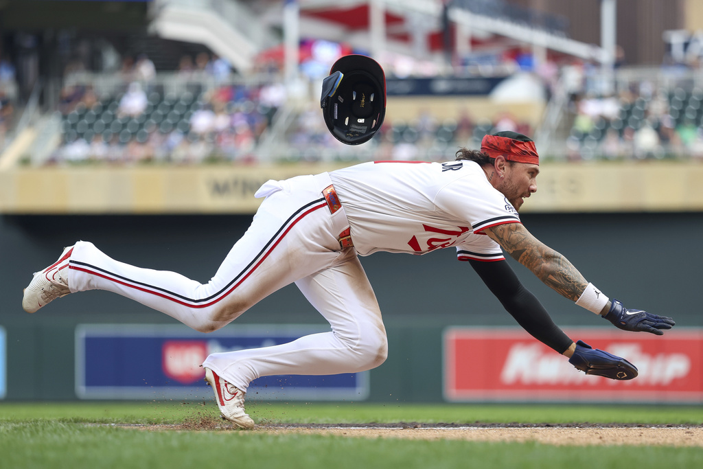 Minnesota Twins' DaShawn Keirsey Jr. leaps to scores on a sacrifice fly hit by Byron Buxton during the sixth inning of a baseball game against the Chicago White Sox, Monday, Sept. 1, 2025, in Minneapolis. (AP Photo/Matt Krohn)
