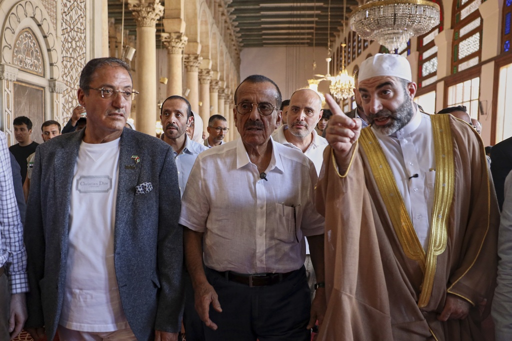 Sheikh Alaa al-Din al-Sayiq, Scientific Director of the Umayyad Mosque, right, hosts Emirati business magnate Khalaf al-Habtoor, chairman of the Al Habtoor Group, during a visit to the mosque as part of a delegation trip to explore investment opportunities in Syria, in the Old City of Damascus on Tuesday, Sept. 9, 2025.(AP Photo/Omar Albam)