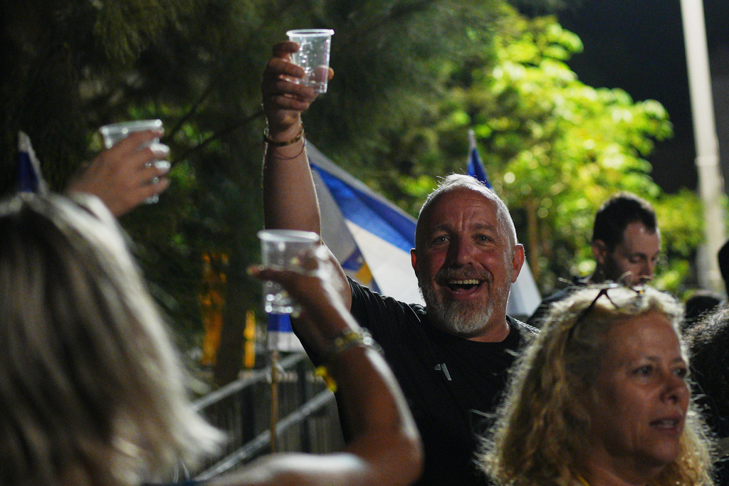 Relatives and supporters of Israeli hostages held by Hamas in the Gaza Strip celebrate after the announcement that Israel and Hamas have agreed to the first phase of a peace plan, as they gather at a plaza known as the hostages square in Tel Aviv, Israel, Thursday, Oct. 9, 2025. (AP Photo/Emilio Morenatti)