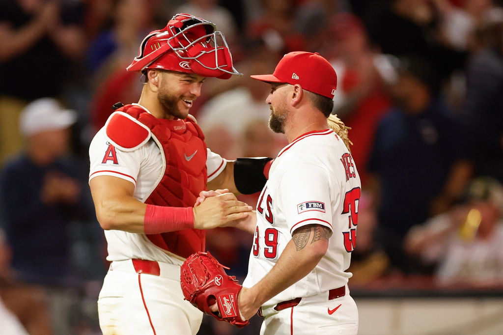 Los Angeles Angels catcher Logan O'Hoppe, left, Los Angeles Angels relief pitcher Kirby Yates, right, react following the Los Angeles Angels' victory over the Athletics during a baseball game Saturday, June 27, 2026, in Anaheim, Calif. (AP Photo/Caroline Brehman)
