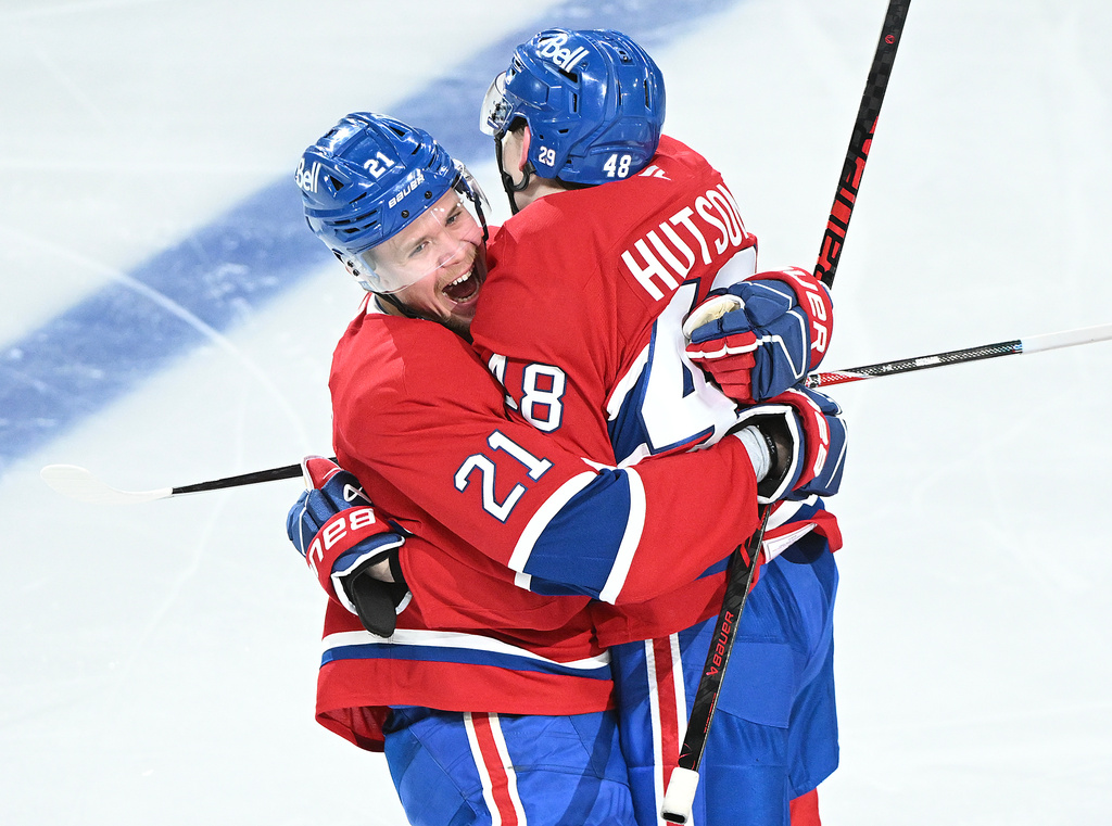 Montreal Canadiens' Lane Hutson (48) celebrates with teammate Kaiden Kuhle (21) after scoring against the Tampa Bay Lightning during overtime of Game 3 in a first-round NHL hockey Stanley Cup playoff series in Montreal, Friday, April 24, 2026. (Graham Hughes/The Canadian Press via AP)