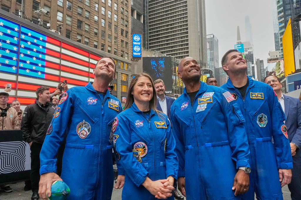 From left, NASA's Artemis II astronauts Reid Wiseman, Christina Koch, Victor Glover, and Jeremy Hansen watch a replay of their ringing of the closing bell at the Nasdaq MarketSite, in New York's Times Square, Thursday, April 30, 2026. (AP Photo/Richard Drew)