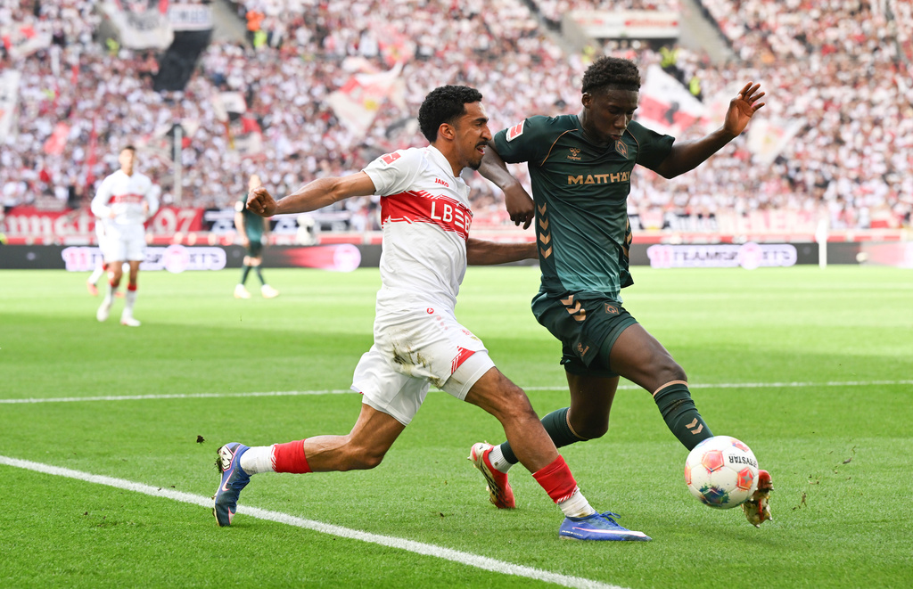 Bremen's Karim Coulibaly, right, and Stuttgart's Tiago Tomas, left, challenge for the ball during the German Bundesliga soccer match between VfB Stuttgart and Werder Bremen in Stuttgart, Germany, Sunday, April 26, 2026. (Bernd Weissbrod/dpa via AP)