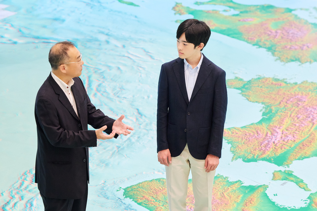 In this photo provided by the Imperial Household Agency of Japan, Japan's Prince Hisahito, right, visits the Science Museum of Map and Survey in Tsukuba, Ibaraki prefecture, Japan, on Aug. 13, 2026, ahead of his 20th birthday on Sept. 6, 2026. (The Imperial Household Agency of Japan via AP)