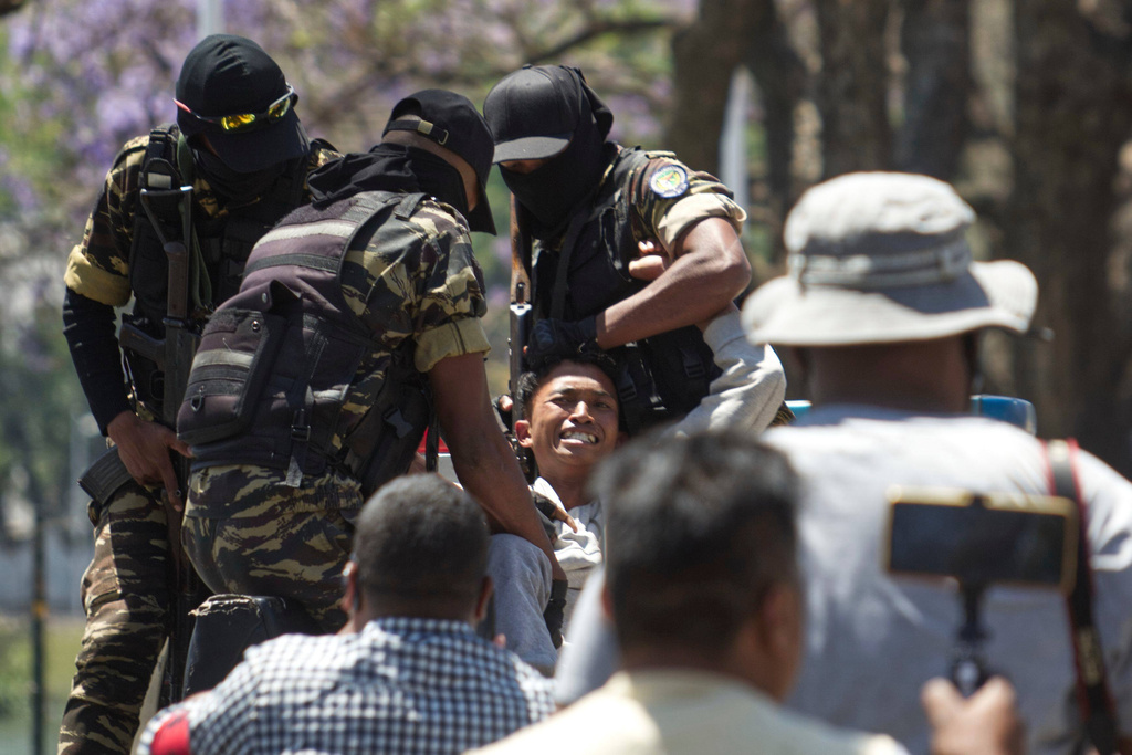 Police arrest a demonstrator during a protest calling for president to step down in Antananarivo, Madagascar, Thursday, Oct. 9, 2025. (AP Photo/Alexander Joe)