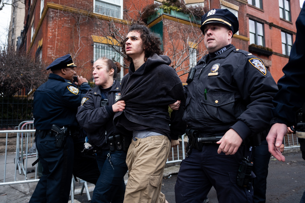 Police detain Emir Balat after he attempted to detonate an improvised explosive device during a counterprotest against far right influencer Jake Lang staging an anti-Islam protest outside Gracie Mansion, Saturday, March 7, 2026, in New York. (AP Photo/Julius Constantine Motal)