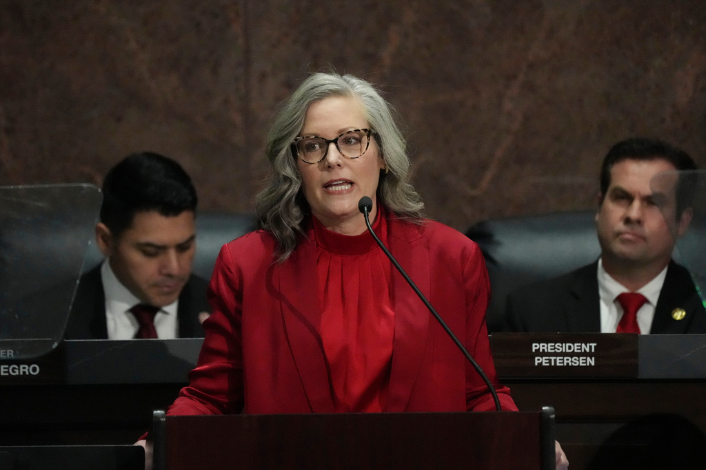Arizona Democratic Gov. Katie Hobbs speaks during her State of the State address in the House of Representatives at the Capitol with Speaker of the House Rep. Steve Montenegro, R-Litchfield Park, left, and Senate President Warren Petersen, R-Gilbert, flanking the governor, Monday, Jan. 12, 2026, in Phoenix. (AP Photo/Ross D. Franklin)