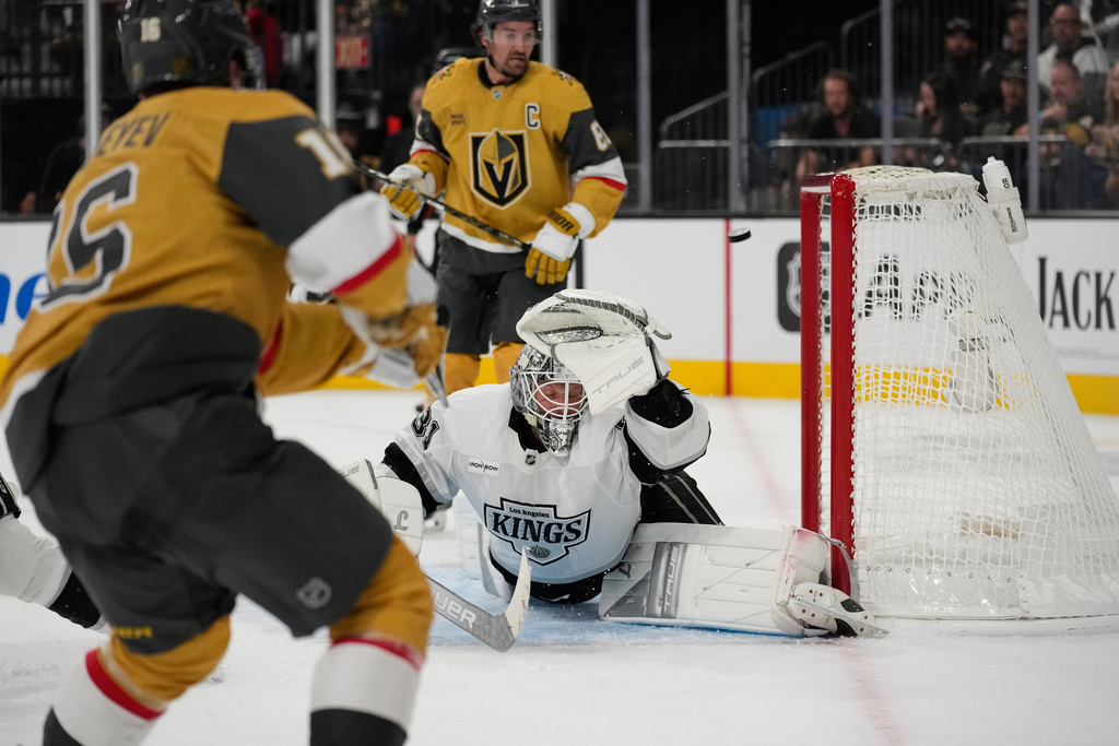 Vegas Golden Knights right wing Pavel Dorofeyev, left, scores his third goal of the game against Los Angeles Kings goaltender Anton Forsberg (31) during the second period of an NHL hockey game Wednesday, Oct. 8, 2025, in Las Vegas. (AP Photo/John Locher)
