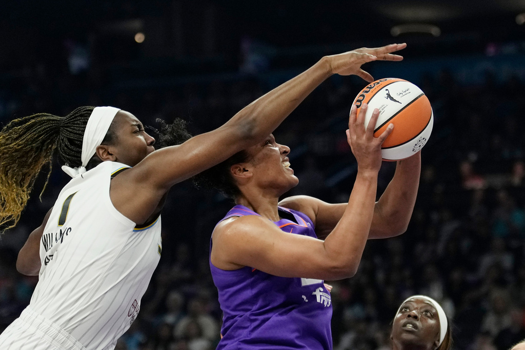Chicago Sky center Elizabeth Williams (1) blocks a shot by Phoenix Mercury forward Alyssa Thomas during the first half of a WNBA basketball game, Friday, May 15, 2026, in Phoenix. (AP Photo/Ross D. Franklin)