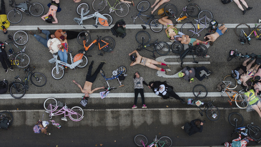 EDS NOTE: NUDITY - Cyclists in the Naked Bike Ride lay down in protest against Donald Trump's attempts to mobilize the National Guard on the Burnside Bridge, Sunday, Oct. 12, 2025, in Portland, Ore. (AP Photo/Jenny Kane) EDS NOTE: NUDITY - Cyclists in the Naked Bike Ride lay down in protest against Donald Trump's attempts to mobilize the National Guard on the Burnside Bridge, Sunday, Oct. 12, 2025, in Portland, Ore. (AP Photo/Jenny Kane)