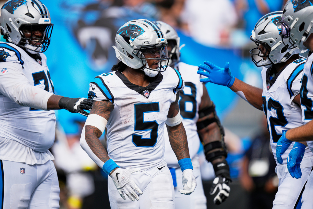 Carolina Panthers running back Rico Dowdle celebrates after scoring against the Miami Dolphins during the second half of an NFL football game, Sunday, Oct. 5, 2025, in Charlotte, N.C. (AP Photo/Jacob Kupferman)