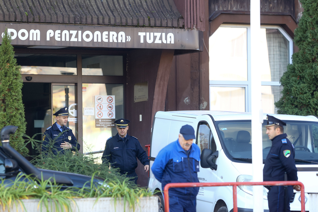 Police officers stand in front of a retirement home following a major fire that killed at least 11 people, in Tuzla, Bosnia, Tuesday, Nov. 5, 2025. (AP Photo)