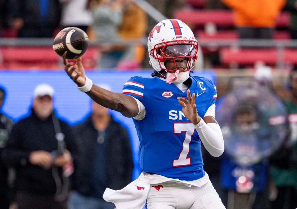 SMU quarterback Kevin Jennings throws a pass during the first half of an NCAA college football game against Miami, Saturday, Nov. 1, 2025, in Dallas. (AP Photo/Jeffrey McWhorter)