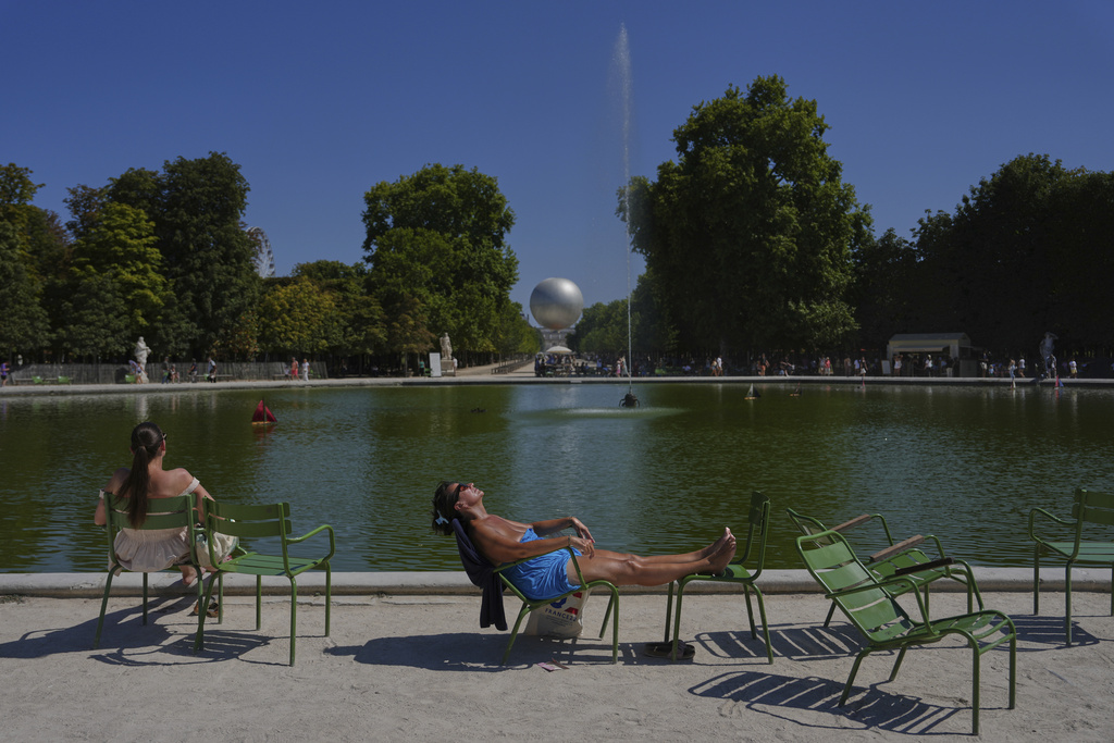 A man sunbaths in the Tuileries gardens, Monday, Aug. 11, 2025 in Paris. (AP Photo/Aurelien Morissard)