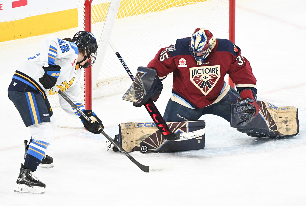 Montreal Victoire goaltender Ann-Renee Desbiens makes a save against Toronto Sceptres' Maggie Connors (22) during the second period of an PWHL hockey game in Laval, Quebec, Wednesday, Jan. 28, 2026. (Graham Hughes/The Canadian Press via AP)