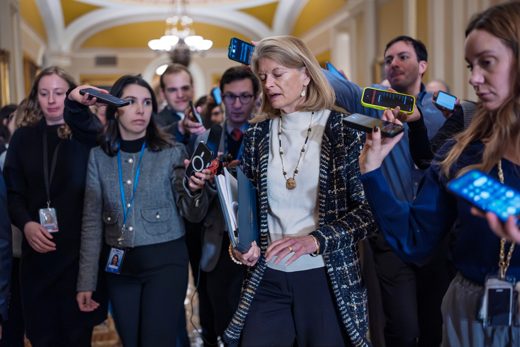 Sen. Lisa Murkowski, R-Alaska, a member of the Senate Appropriations Committee, is surrounded by reporters following a closed-door Republican meeting on spending legislation that funds the Department of Homeland Security and a swath of other government agencies, at the Capitol in Washington, Wednesday, Jan. 28, 2026. (AP Photo/J. Scott Applewhite)