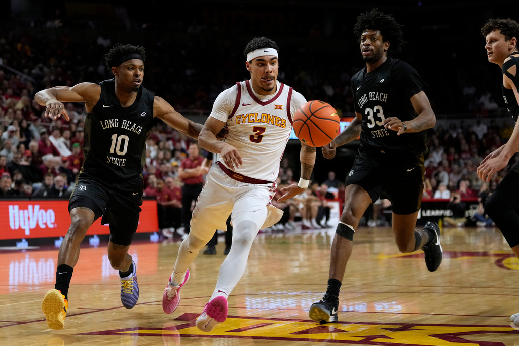 Iowa State guard Tamin Lipsey (3) drives between Long Beach State guard Cole Farrell (10) and forward Shay Johnson Jr. (33) during the first half of an NCAA college basketball game, Sunday, Dec. 21, 2025, in Ames, Iowa. (AP Photo/Charlie Neibergall)