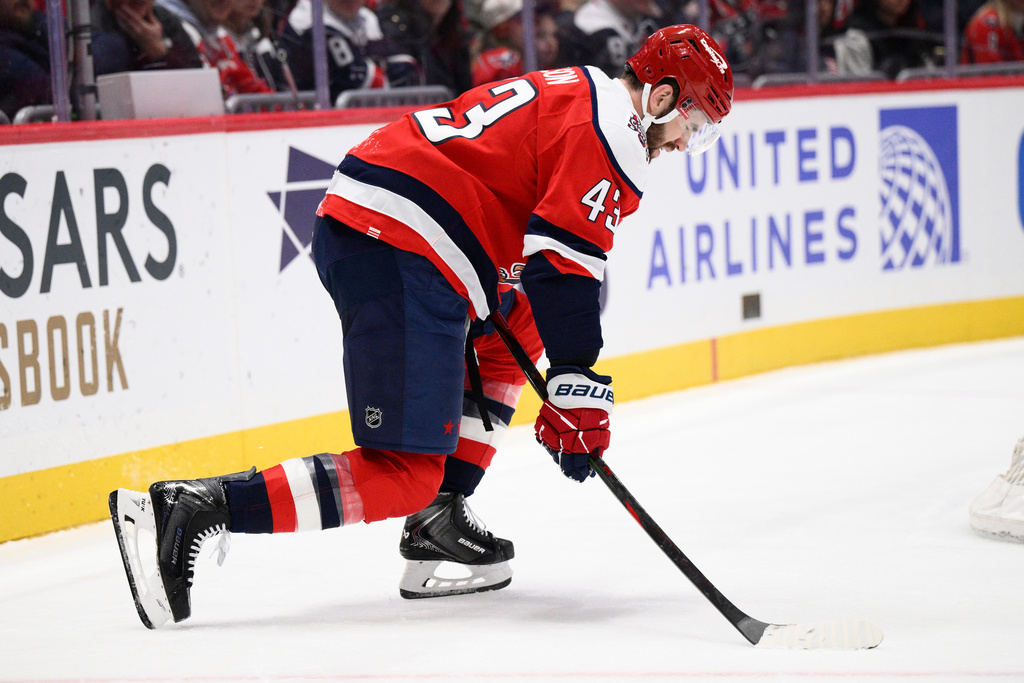 Washington Capitals right wing Tom Wilson (43) grimaces and is slow to get up after being injured during the first period of an NHL hockey game against the Chicago Blackhawks, Saturday, Jan. 3, 2026, in Washington. (AP Photo/Nick Wass)