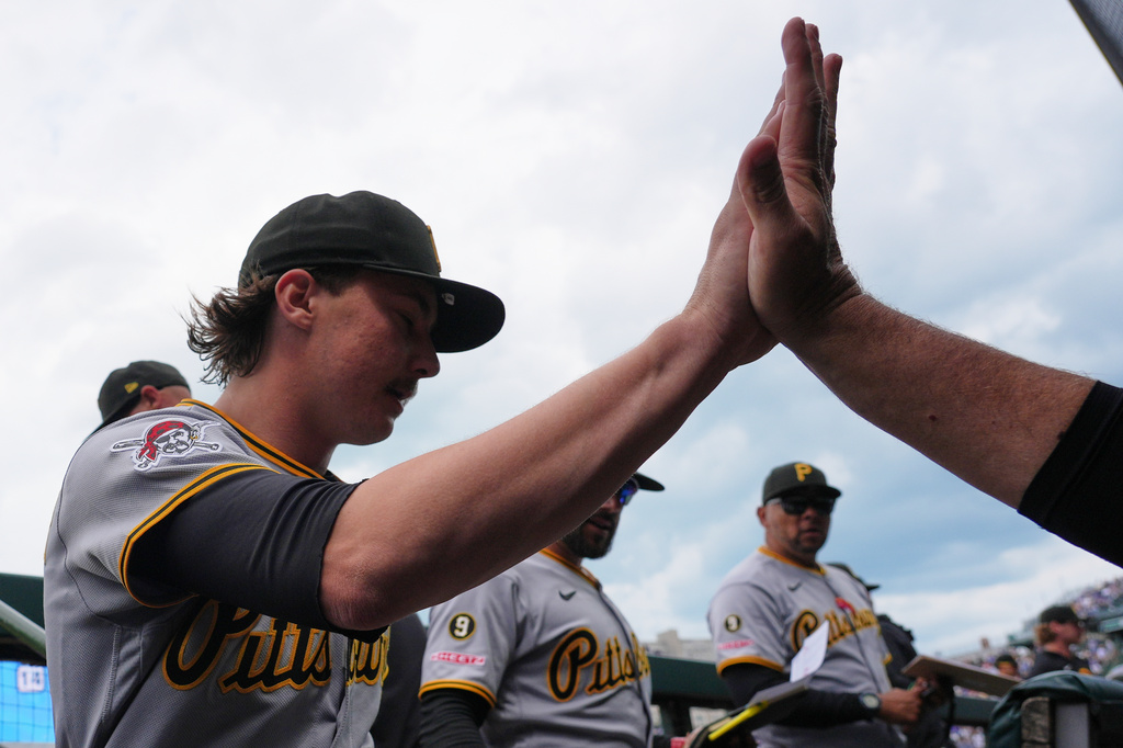 Pittsburgh Pirates starting pitcher Bubba Chandler, left, celebrates with a teammate in the dugout after first inning of a baseball game against the Chicago Cubs in Chicago, Sunday, April 12, 2026. (AP Photo/Nam Y. Huh)