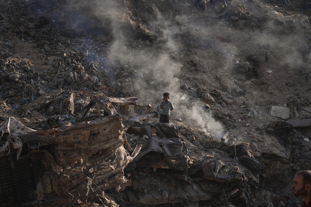 A child searches for plastic at a landfill in Gaza City Monday, June 8, 2026. (AP Photo/Jehad Alshrafi)
