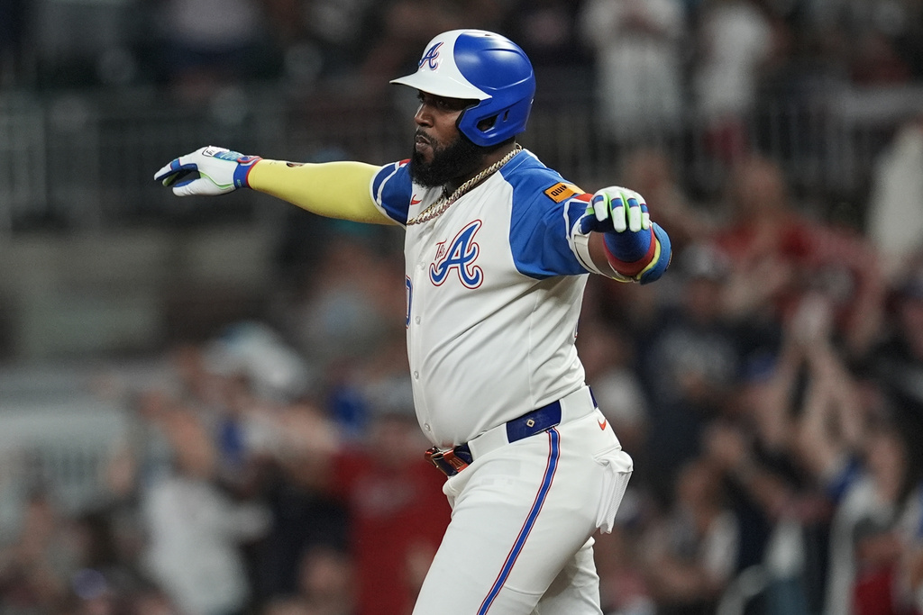 Atlanta Braves designated hitter Marcell Ozuna (20) celebrates his three-run homer against the Miami Marlins in the fifth inning in the second baseball game of a doubleheader, Saturday, Aug. 9, 2025, in Atlanta. (AP Photo/Mike Stewart)