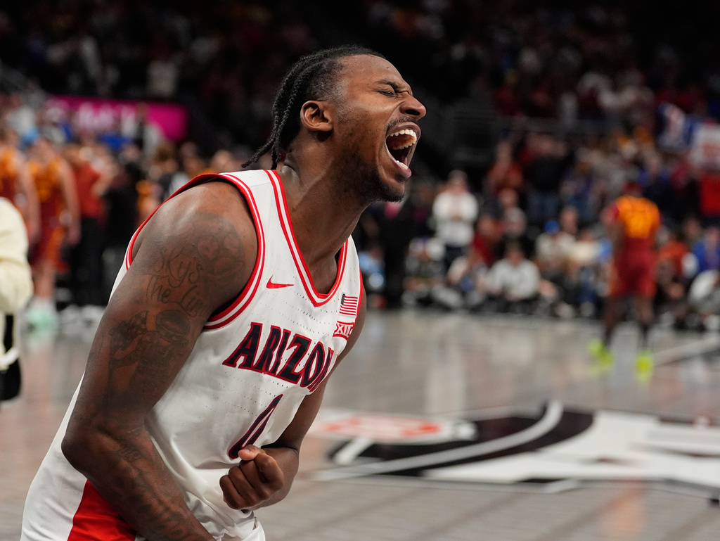 Arizona's Jaden Bradley celebrates after making the game-winning shot at the buzzer to defeat Iowa State during an NCAA college basketball game in the semifinal round of the Big 12 Conference tournament Friday, March 13, 2026, in Kansas City, Mo. (AP Photo/Charlie Riedel)