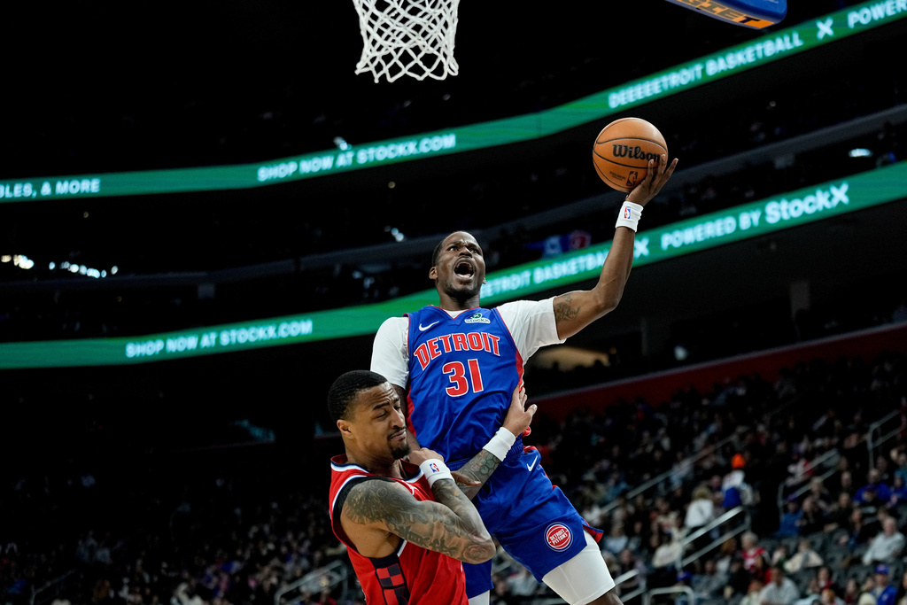 Detroit Pistons guard Javonte Green, right, shoots against Los Angeles Clippers forward John Collins during the first half of an NBA basketball game Saturday, January 10, 2026, in Detroit. (AP Photo/Ryan Sun)