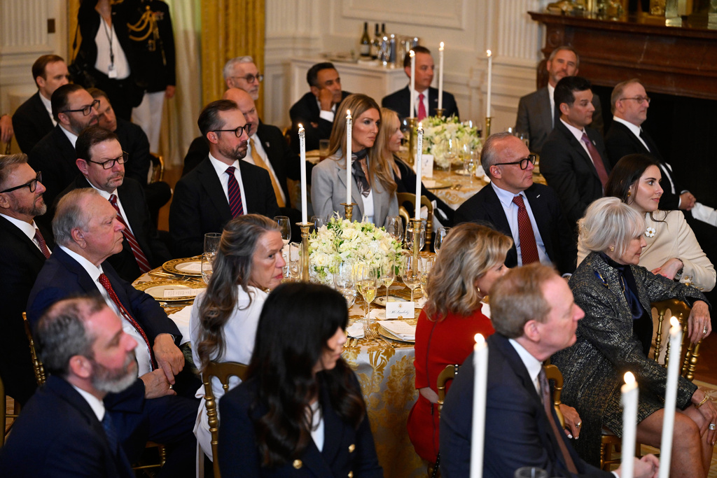 Guests listens as President Donald Trump addresses a dinner for donors who have contributed to build the new ballroom at the White House, Wednesday, Oct. 15, 2025, in Washington. (AP Photo/John McDonnell)