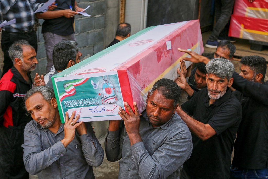 A coffin is carried during the funeral of mostly children killed in a strike Feb. 28 at a girls' elementary school in Minab, Iran, Tuesday, March 3, 2026. (Abbas Zakeri/Mehr News Agency via AP)