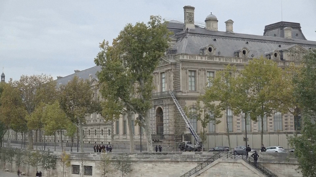 This grab taken from video shows police standing outside the Louvre museum, Sunday, Oct. 19, 2025 in Paris. (AP Photo)