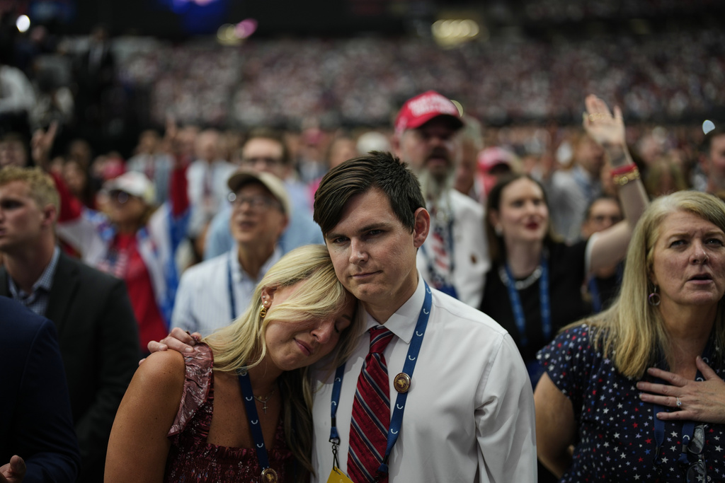A woman is overcome with emotion while watching a Charlie Kirk tribute video during a memorial for the conservative activist Sunday, Sept. 21, 2025, at State Farm Stadium in Glendale, Ariz. (AP Photo/John Locher)