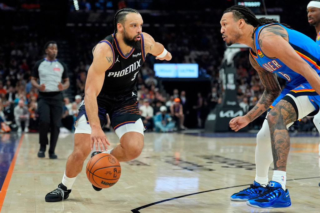 FILE - Phoenix Suns forward Dillon Brooks, left, dribbles the ball against Oklahoma City Thunder forward Jaylin Williams (6) during the first half of Game 4 in a first-round NBA playoffs basketball series, Monday, April 27, 2026, in Phoenix. (AP Photo/Ross D. Franklin,File)