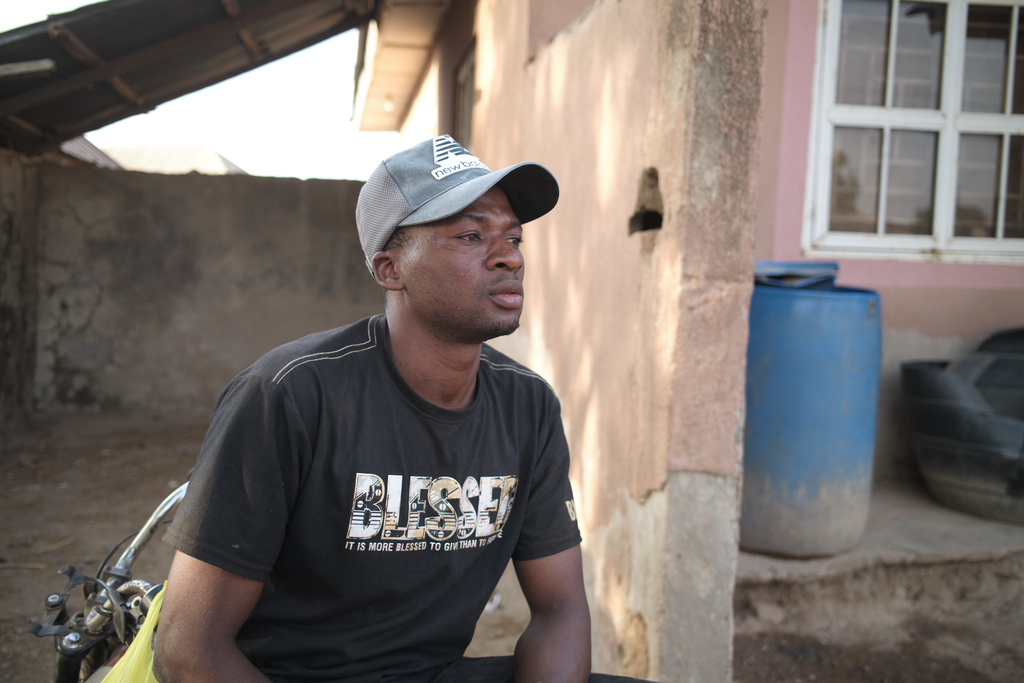 Umar Bio Kabir, a 26-year-old schoolteacher who survived by running when the attackers arrived in the village of Woro, looks on in Woro, Nigeria, Thursday, Feb. 5, 2026. (AP Photo/Pelumi Salako)