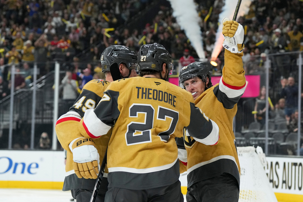 Vegas Golden Knights right wing Mitch Marner (93) celebrates his goal with teammates against the Calgary Flames during the second period of an NHL hockey game Thursday, April 2, 2026, in Las Vegas. (AP Photo/Candice Ward)
