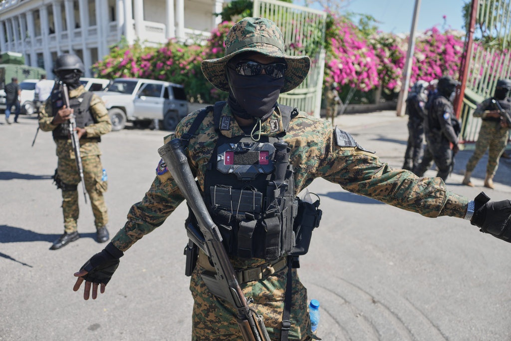 Members of the National Palace General Security Unit (USGPN) set up a security perimeter as Transitional Council President Laurent Saint-Cyr visits the headquarters of the armed forces in Port-au-Prince, Haiti, Monday, Jan. 26, 2026. (AP Photo/Odelyn Joseph)