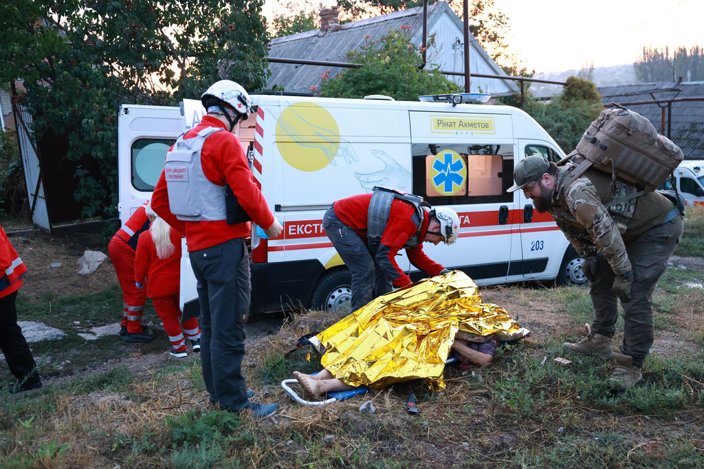 Medics inspect a body of a woman killed in a Russian strike on residential neighbourhood on Zaporizhzhia, Ukraine, on Saturday, Sept.26, 2026. (AP Photo/Kateryna Klochko)