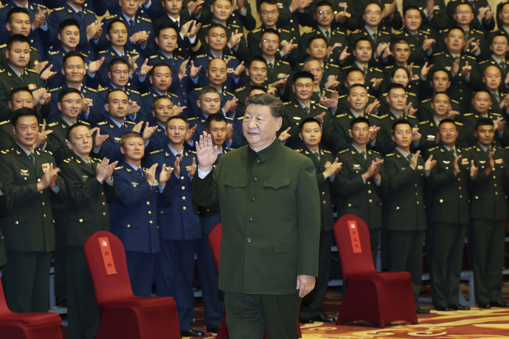 In this photo released by Xinhua News Agency, Chinese President Xi Jinping meets with representatives of military personnel stationed in Lhasa in western China's Tibet Autonomous Region on Wednesday, Aug. 20, 2025. (Li Gang/Xinhua via AP)