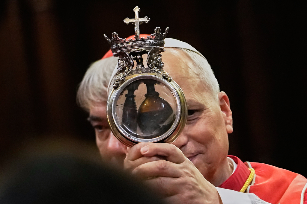 Pope Leo XIV holds up a ceremonial ampoule that Catholic tradition says contains the blood of Naples' patron saint, Saint Gennaro, whose dried blood is believed by the faithful to liquefy during recurring ceremonies in the city, in Naples, Friday, May 8, 2026, during a one-day pastoral visit to Pompeii and Naples. (AP Photo/Gregorio Borgia)