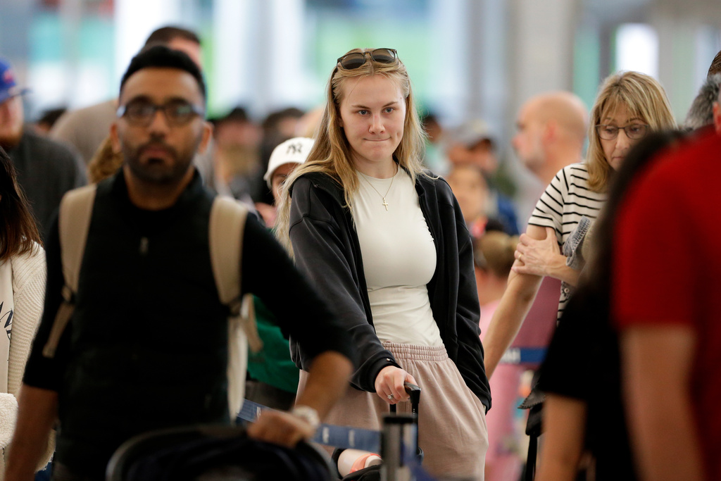 Air travelers endure long lines and two-hour wait times at the TSA security check point at Terminal E at the George Bush Intercontinental Airport Friday, March 20, 2026, in Houston. (AP Photo/Michael Wyke)