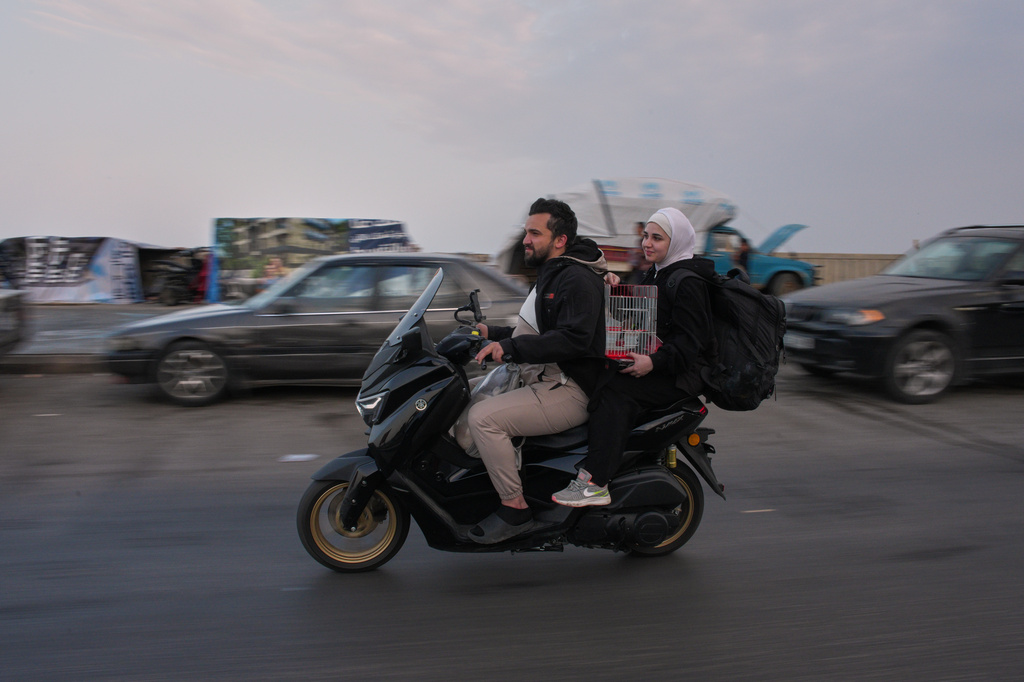 Displaced residents drive a motorcycle back to their villages following a ceasefire between Israel and Hezbollah, in Saida, Lebanon, Friday, April 17, 2026. (AP Photo/Hassan Ammar)